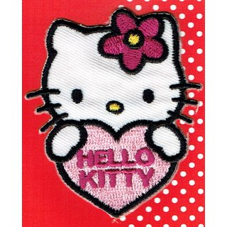 Hello Kitty, weiße Katze, mit pinker Blume am Ohr, hält ein rosa Herz in den Pfoten mit pinkem Schriftzug 'Hello Kitty'